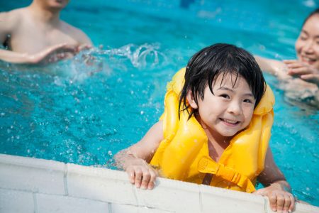 child wearing life vest in pool