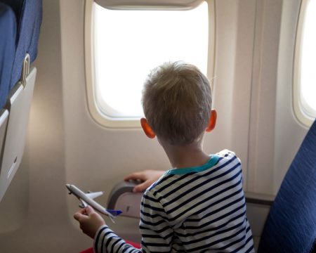 boy sitting on plane