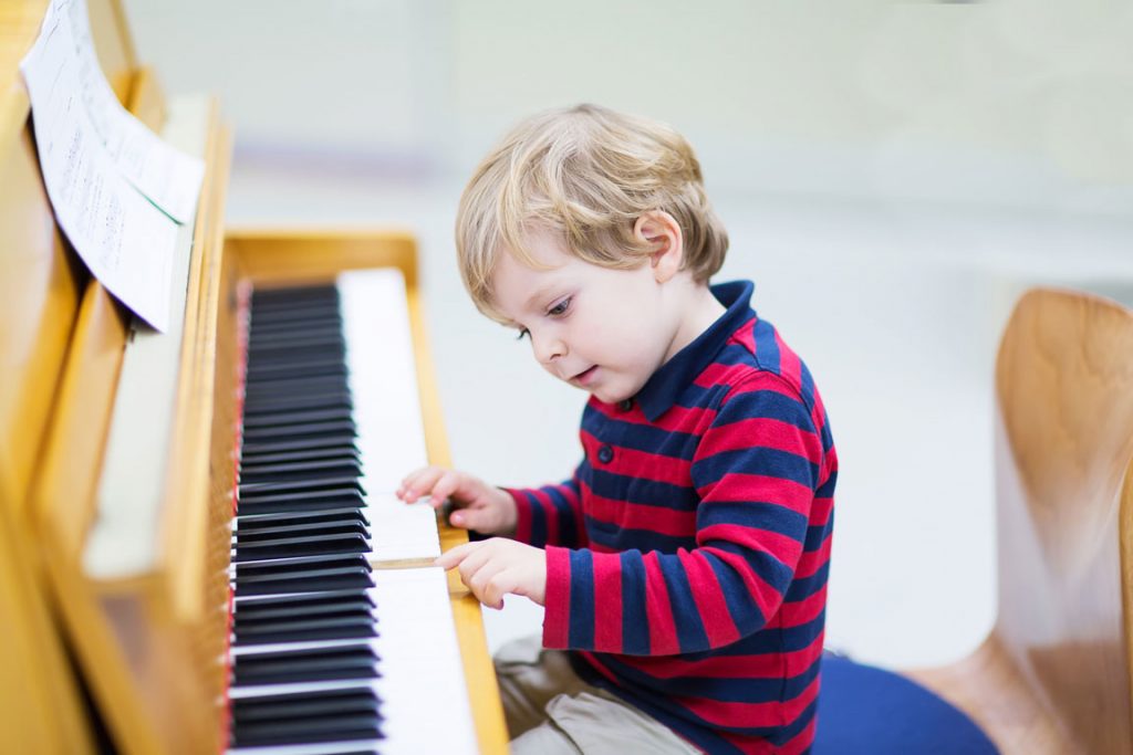 young boy learning piano