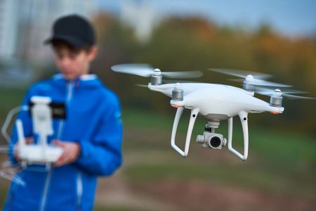 young boy piloting drone