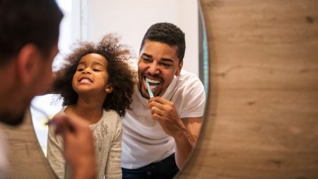 Father and daughter brushing teeth feature image